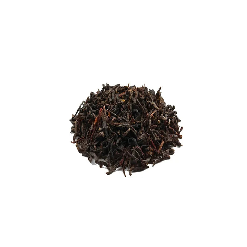 Close-up of Golden Black Tea leaves and cassia seed blend used in large commercial tea bags.