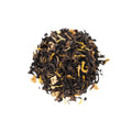 Close-up of semi-ball-shaped White Peach Oolong tea leaves with fruit pieces.